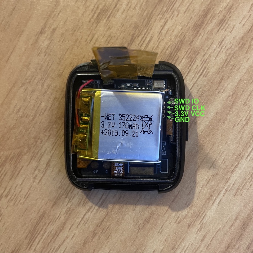 To the right of the battery, the SWD test points are visible. You may need to scooch the battery over (or carefully peel it up) to reveal these.